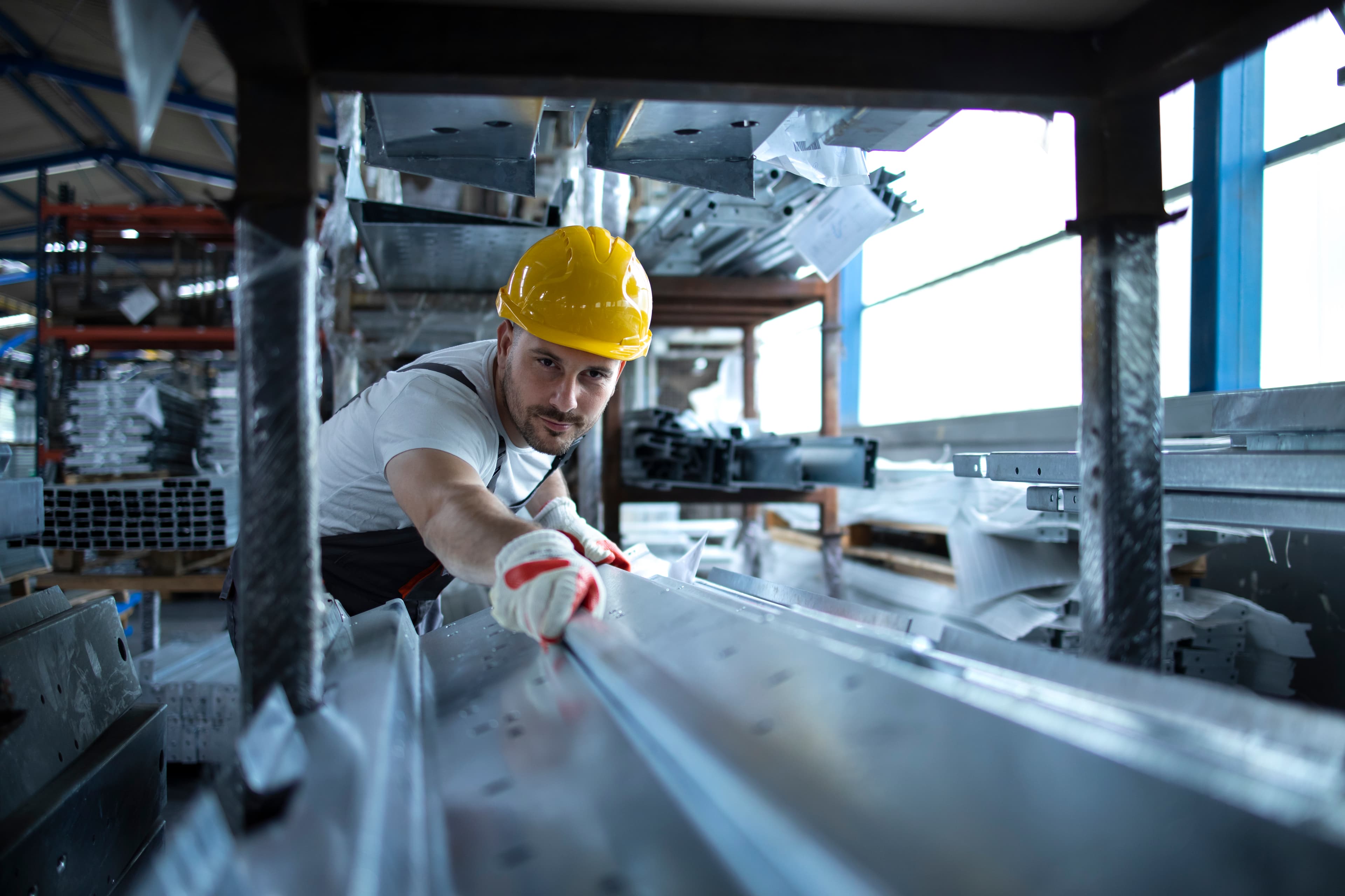 Construction worker with metal sheets